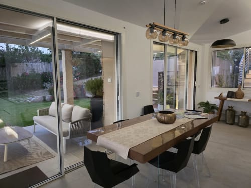 Modern dining area in Villagì Luxury Villa, Cagliari with sea view, open to garden patio and outdoor seating