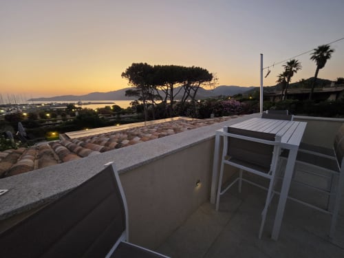 Luxury villa terrace at sunset with sea view, Cagliari, featuring private pool and dining area