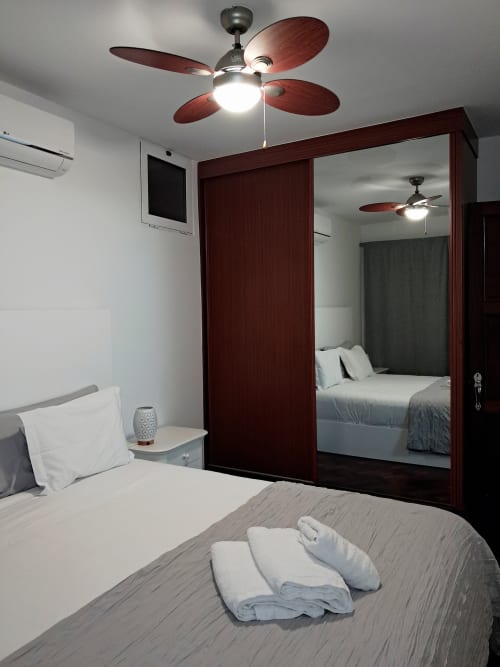 Bedroom at Villa Supranee, Câmara de Lobos with sea view, featuring bed, mirror wardrobe, and ceiling fan