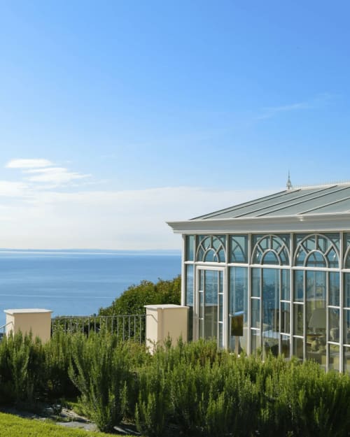 Villa con piscina Le Selve affacciata sul Lago di Garda, con moderna veranda in vetro, verde paesaggistico e cielo limpido