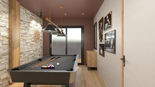 Salle de jeu moderne à la Villa Acacia aux Villas de Jade avec billard, éclairage suspendu et mur en pierre