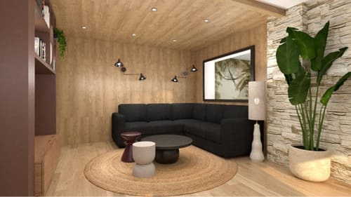 Élégant séjour des Villas de Jade avec canapé sectionnel noir, boiseries intérieures et plante en pot.