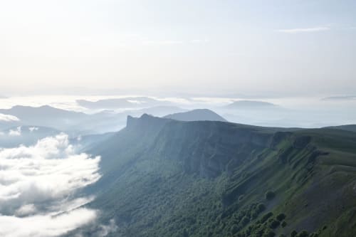 Aerial view of lush green mountains with mist near Posada de Ollo hotel in Ollo, Spain