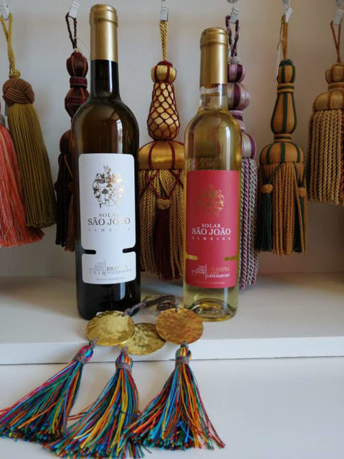 Solar de São João wine bottles with decorative tassel ornaments displayed at Portuguese Quinta das Pias hotel