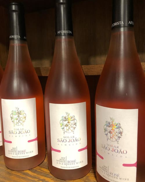 Three bottles of Solar São João rosé wine from Portugal displayed on wooden shelf at RISOTURISMO