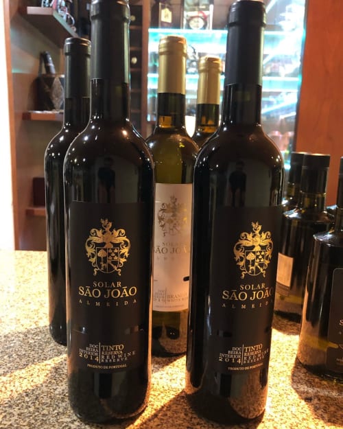 Solar São João Almeida wine bottles displayed at RISOTURISMO Portuguese wine tasting venue