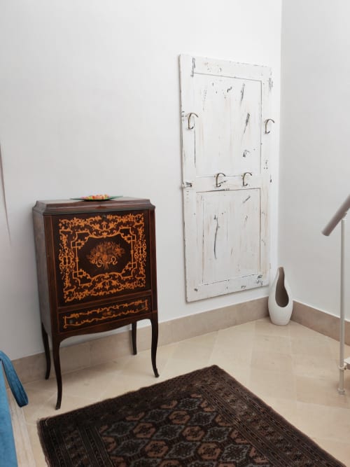 Angolo dell'appartamento in stile vintage a Sicily Confort Maison con mobile in legno intarsiato e porta imbiancata