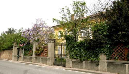 Ingresso del Bresbot B&B a Bressana con glicini in fiore, muri ricoperti d'edera e cancello ornamentale