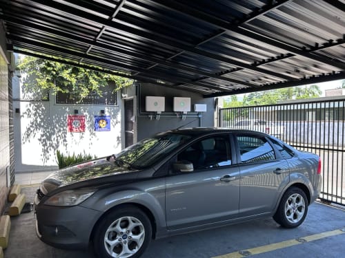Sedã cinza estacionado na garagem coberta do apartamento BORA BORA HOSPEDAGENS, Joinville Brasil