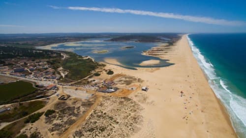 Aerial view of Canha beach with lagoon and coastal dunes near Herdade da Cova da Onça