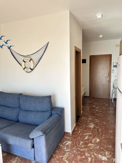 Sofá azul en estudio frente al mar de Apartamentos A la Orilla del Mar, Matalascañas