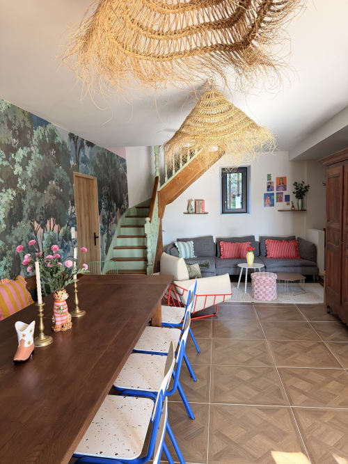 Stylish L'Écrin room at Le Mas de la Vernède, Aramon with woven pendant lights, staircase, and modern furnishings