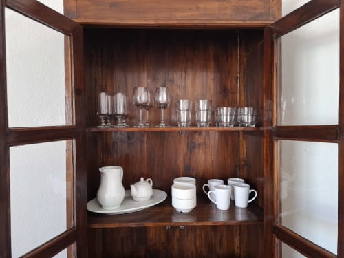 Wooden display cabinet with glassware and white tableware at Villas del Mar, Puerto Calero villa