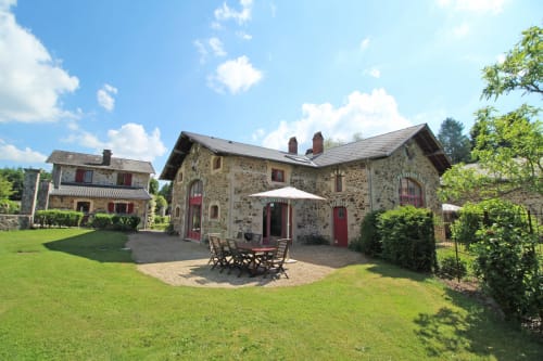 Stone cottage with garden patio at Domaine de Bort, a historic guesthouse near Limoges, France
