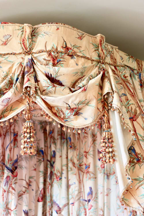 Ornate beige floral curtains with beaded tassels at Domaine de Bort luxury room near Limoges