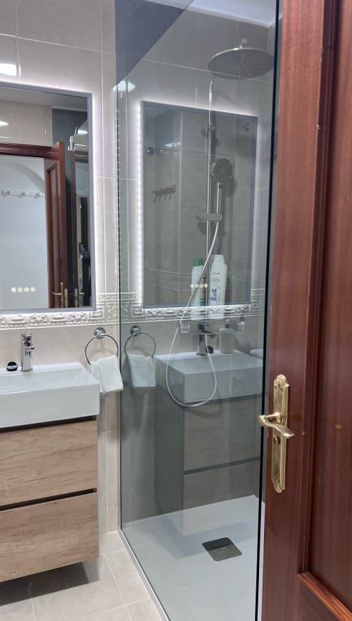 Modern glass-enclosed shower with rainfall showerhead in Brisa Marina apartment bathroom, Mazagon