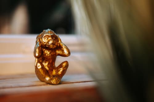 Golden monkey figurine on wooden surface at Boutique & Unique Shrewsbury Rooms