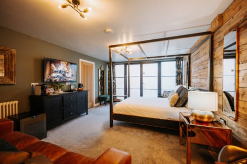 Luxury king bedroom at Baschurch House Shrewsbury with canopy bed, wooden features, and modern amenities
