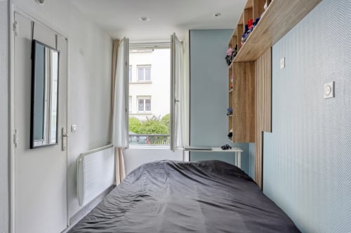 Chambre moderne à l'hôtel Queen And King à Versailles avec vue sur le jardin, télévision et étagères en bois