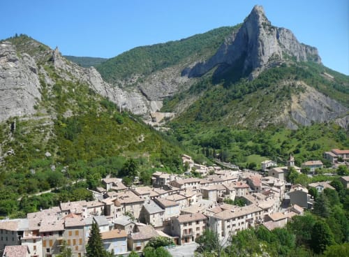 Barret-sur-Méouge village nestled in rocky valley with dramatic limestone cliffs, near Domaine de la Méouge