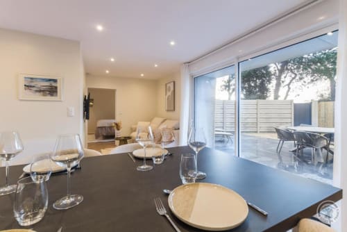 Elegant dining area at La Bergerie De Montitier cottage with garden views through large windows