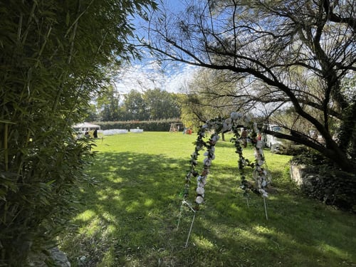 Vue ensoleillée du jardin des Jardins Du Soleil B&B à Avignon avec porche orné et pelouse verdoyante