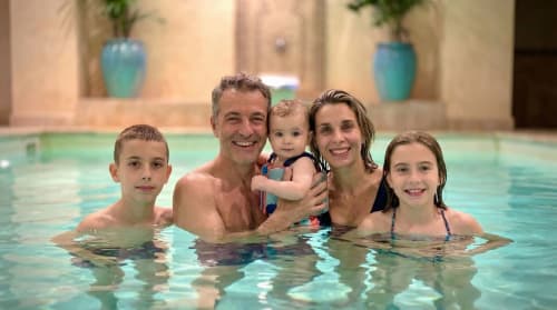 Happy family enjoying indoor pool at Le Clos Des Anges B&B in Bagnols, France