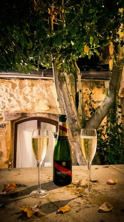 G.H. Mumm champagne bottle with two filled flutes at Le Clos Des Anges B&B in Bagnols, France