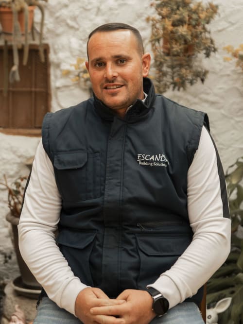 Man in Escanda Building Solutions vest at hotel entrance in Spain