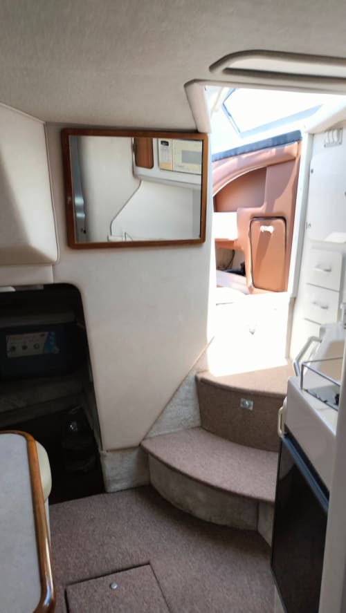 Lujosa cabina de yate en La Isla Acapulco Diamante con asientos tapizados, detalles de madera y vistas al océano