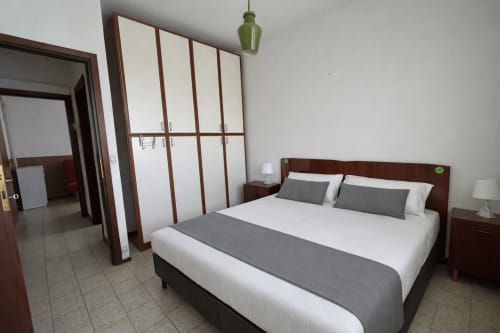 Comfort apartment bedroom at Anthea hotel in Lignano Sabbiadoro with queen bed, wardrobe, and modern furnishings