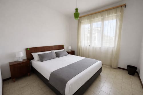 Comfort apartment bedroom at Anthea hotel in Lignano Sabbiadoro with queen bed, nightstands, and terrace access