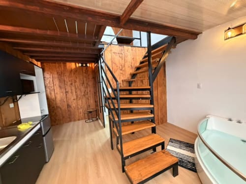 Modern loft-style chalet with wooden spiral staircase, kitchenette, and hot tub in Heredia, Costa Rica