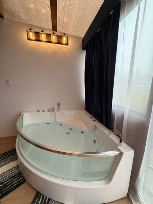 Luxury whirlpool tub with glass enclosure in spa-like bathroom at Chalets Vistas del Poas, Costa Rica