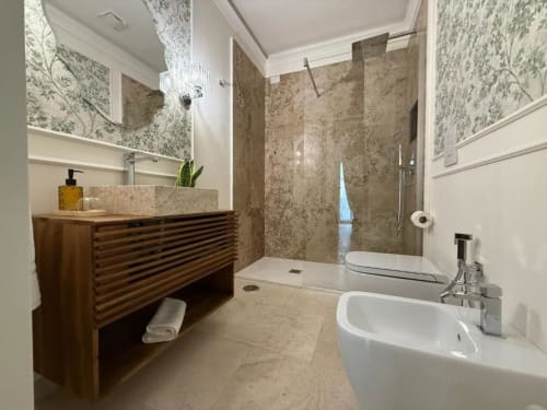 Modern bathroom at Residenza Seconnino Naples hotel with double sink, walk-in shower, wood vanity and green botanical