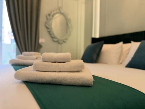 Folded towels on bed at Residenza Seconnino hotel in Naples, Italy