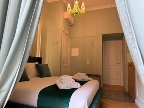 Cozy double bedroom at Residenza Seconnino in Naples with elegant chandelier and modern amenities