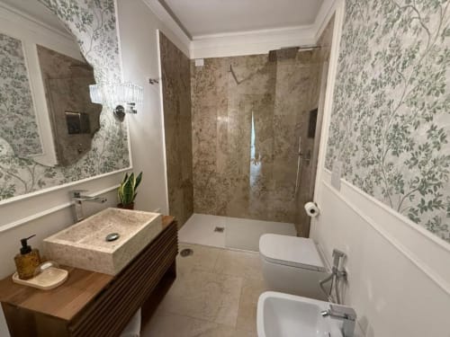Modern bathroom at Residenza Seconnino Naples with marble shower, vessel sink, and botanical wallpaper