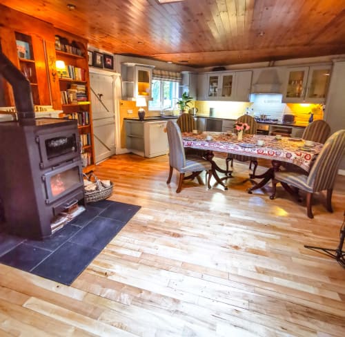Spacious cottage dining and kitchen area with wood ceilings, fireplace, and garden views at Kilmokea Country Manor in Wexford