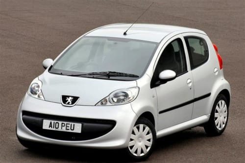 White Peugeot 107 compact car with red accents parked on asphalt near Lecce, Italy hotel