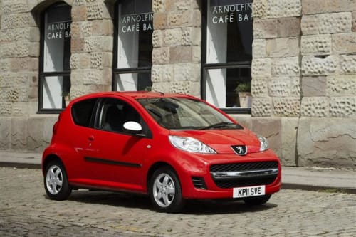 Bright red Peugeot parked in front of Arnolfini Café Bar in historic Lecce, Italy