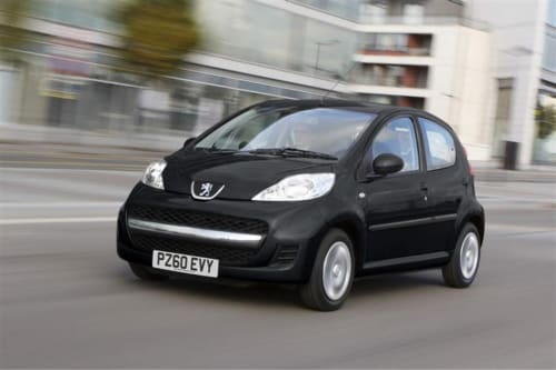 Black Peugeot 107 car driving on urban street near Lecce hotel accommodation