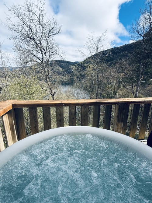 Hot tub on deck overlooking Ain Lake at Cabanes et lodges du Belvédère in Serrières-sur-Ain