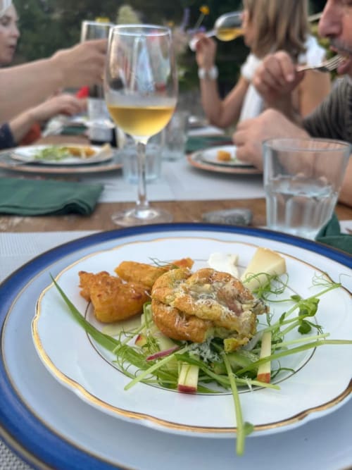 Gourmet plated dish with seared shrimp, roasted vegetables, and fresh greens at Agriturismo Colle Mura in Gualdo Tadino