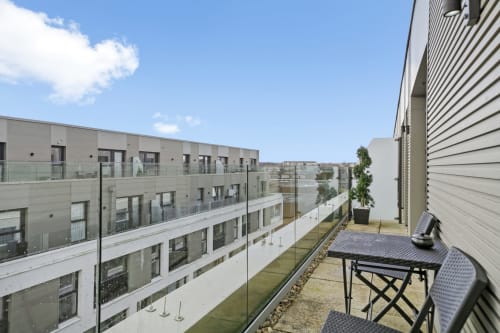 Luxury penthouse balcony at Towerserve Properties, Stevenage. Modern apartment terrace with seating overlooking contemporary