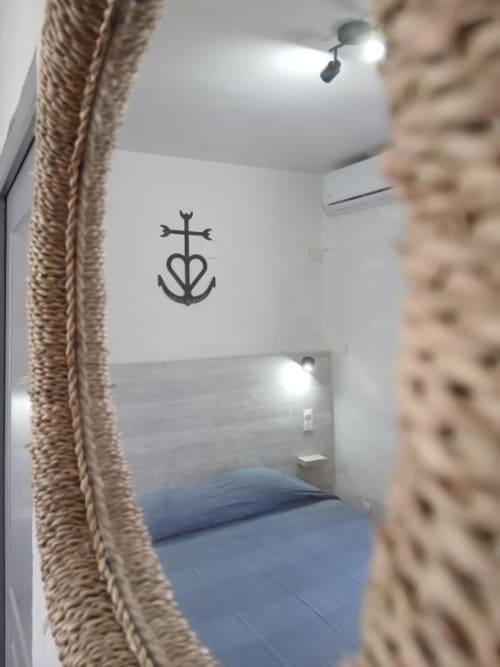 Hôtel Quai d'Azur double room with nautical cross-heart symbol on white wall and blue bedding
