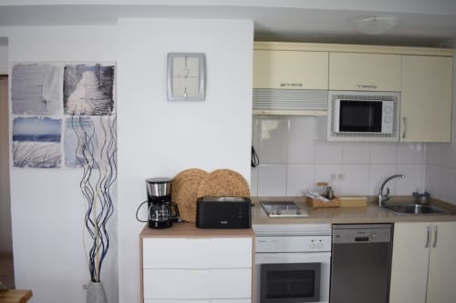 Modern apartment kitchen in Costa Adeje with appliances, counter space, and cooking basics