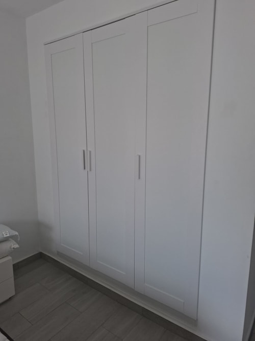 White built-in wardrobe with silver handles in Costa Adeje apartment bedroom