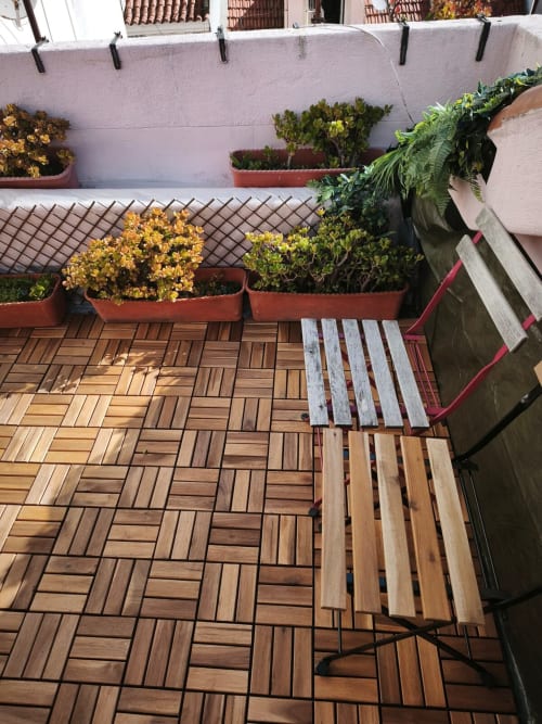 Terraço em madeira com flores em vasos e toldo branco no Lisbon Heart Pulse Stays, Bairro Alto