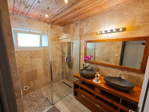 Salle de bain luxueuse avec vasques en pierre, douche à l'italienne, vanité en bois et miroirs chauffants à La Kaz 57